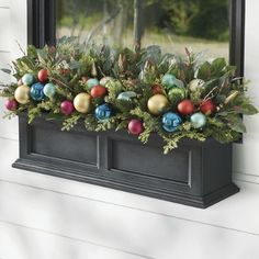 a window box filled with ornaments and greenery