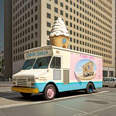 an ice cream truck is parked on the side of the road in front of tall buildings