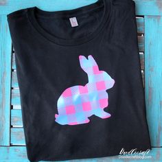 a black t - shirt with a pink and blue rabbit on it