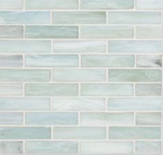 a white tile wall with light green and gray colors