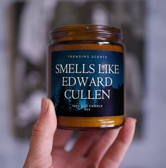 someone holding a candle in their hand that says smells like edward gullen