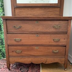 an old wooden dresser with mirror on top