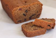 two slices of banana bread sitting next to each other on top of a white surface