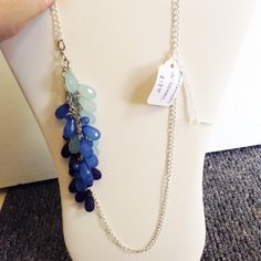 "This silver curb chain has 3 tiers of 3 different blue teardrop acrylic beads cascading down off the chain.  It makes for an interesting waterfall effect.  The colors of blue go from light to a dark blue.  Lots of different ways you can wear this necklace.  I like it all off to one side for a different look.  The necklace measures 26\" in length and does not have a clasp." Blue Briolette Drop Necklace, Blue Teardrop Necklace With Adjustable Chain, Adjustable Blue Teardrop Drop Necklace, Adjustable Teardrop Blue Drop Necklace, Handmade Blue Teardrop Pendant Drop Necklace, Handmade Blue Teardrop Drop Necklace, Handmade Blue Long Drop Necklace, Handmade Blue Necklace With Long Drop, Handmade Blue Necklaces With Long Drop Shape