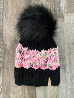 This listing is for a hand knit with 100% merino wool hat knit using Malabrigo Rasta wool in the colour Black with Hedgehog Fiber yarn in Puppy Love. It's topped with a handmade faux-fur pom that is secured to the hat with easy removal. It also has a removable suede tag on the brim. Merino wool is water resistant, quick drying, and breathable. High quality merino wool is super soft with long fibers with a small diameter that move with your body and result in no skin irritation.  This hat will fi Black Hand Knitted Beanie For Cold Weather, Black Yarn Beanie, Hand Knitted Wool Crochet Hat, Black Yarn Knitting Pattern, Handmade Black Yarn Beanie, Malabrigo Rasta, Hedgehog Fibres, Wool Hat Knit, Hat Knit