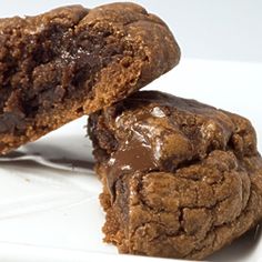 two chocolate cookies sitting on top of a white plate