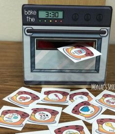 a toaster oven sitting on top of a wooden table filled with cards and magnets