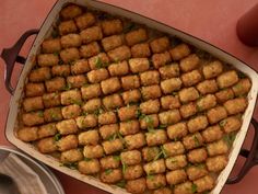 a pan filled with tater tots on top of a table