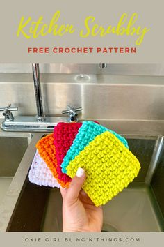 a hand holding four crochet dishcloths in front of a kitchen sink