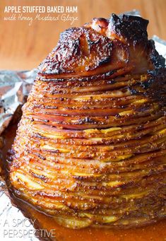 a stack of pancakes covered in syrup on top of aluminum foil with the words apple stuffed baked ham written above it