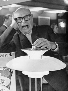 black and white photograph of an old man at a table with a martini glass in front of him