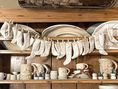 a shelf filled with dishes and plates on top of wooden shelves