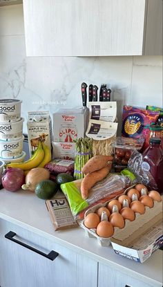 the counter is covered with eggs, vegetables and other food items on it's side