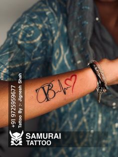 a person with a tattoo on their arm holding a cell phone in one hand and writing on the other