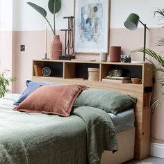 an image of a bedroom setting with plants on the nightstands and bookshelves