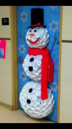 a snowman made out of toilet paper on the door to an elementary school classroom