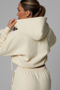 With its wonderfully puffy fit and fleece-lined interior, this jacket will be the coziest in your closet. It has a hood, a full front zipper, ribbed cuffs and a ribbed hem that’s cropped at the waist. It’s a perfect match with the Heavy Cotton Sweatpants for movie marathons, all-day errands, or anytime you want to look cute and feel totally comfortable. Fits true to size—designed for a slightly puffy silhouette with medium fill and a cropped hem. Size down if you prefer a less puffy fit. 100% pr Fall Cropped Hoodie With Ribbed Cuffs, Cotton Puffer Jacket With Ribbed Cuffs, White Cropped Zip Up Hoodie, Fall Half-zip Track Jacket With Drawstring Hood, Casual Half-zip Activewear With Drawstring Hood, Cotton Sweatpants, Movie Marathon, Jacket Sale, Front Zipper