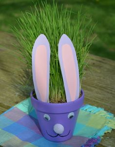 an easter bunny planter with fake grass in it