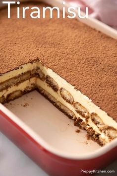 there is a cake that has been cut in half with the words tiamisu on it