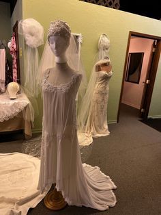 mannequins dressed in wedding dresses and veils on display