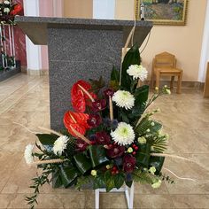 a bouquet of flowers sits in front of a memorial stone at the end of a hall