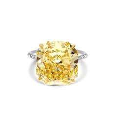 a fancy yellow diamond ring set in 18k white gold