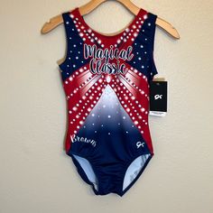 a red, white and blue leotard swimsuit hanging on a wall