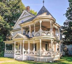 an old victorian style house with white trim