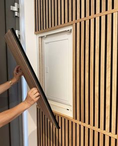 a woman is working on a paneled wall