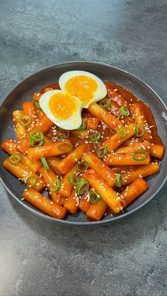 a plate with carrots and an egg on top