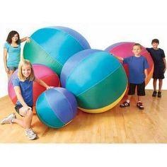 children playing with giant inflatable balls on the floor