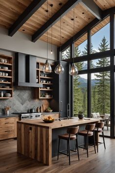 a large kitchen with wooden floors and lots of counter space in front of the windows