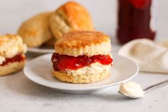 biscuits with jam and cream are on a plate