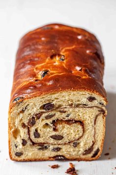 a close up of a loaf of bread with raisins