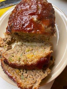 sliced meatloaf on a plate with sauce