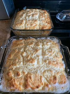 two pans filled with food sitting on top of a stove