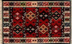 a red and black rug with many different designs