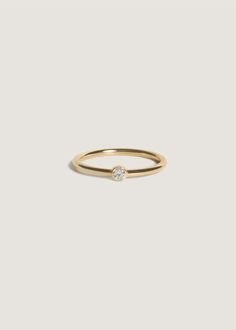 a yellow gold ring with a single diamond