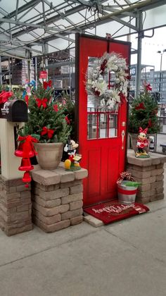 a red door with wreaths and decorations on it