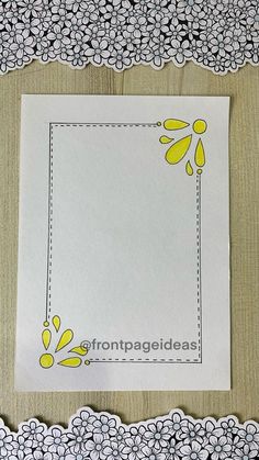 a piece of paper with yellow and white flowers on it next to a doily