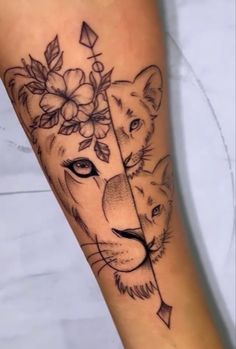 a woman's leg with a lion and flower tattoo on the calf, which has an arrow in it