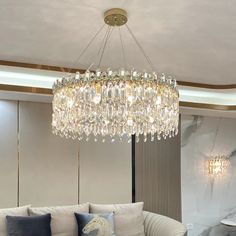 a living room filled with furniture and a crystal chandelier hanging from the ceiling