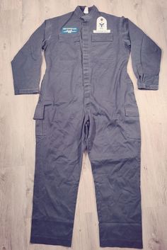 Military suit. This suit has several hook-and-loop pockets. It has a Velcro closure. Badges are sewn above each pocket. Dimensions: Shoulders: 53 cm Chest: 65 cm Arm length: 65 cm Total length: 160 cm Between legs: 76 cm Weight: 1300 grams Fitted Utility Overalls With Pockets, Utility Overalls With Patch Pockets For Work, Workwear Overalls With Pockets, Workwear Overalls With Patch Pockets, Fitted Utility Overalls For Workwear, Cotton Overalls With Multiple Pockets For Work, Flat Front Suits With Pockets For Workwear, Utility Overalls With Pockets For Workwear, Fitted Long Sleeve Overalls With Pockets