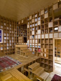 a room filled with lots of wooden shelves covered in bookshelves next to a rug