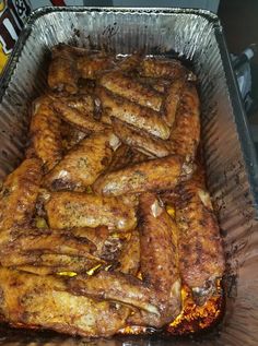 a pan filled with meat sitting on top of a table