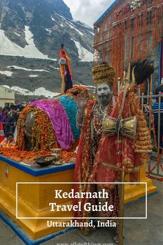 a man in costume standing next to an elephant statue with the words kedraathh travel guide uttrakahand, india