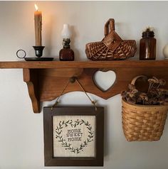 a shelf with some items on it and a basket hanging from the wall next to it