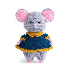 a crocheted mouse wearing a blue and yellow dress with pink ears on it's head