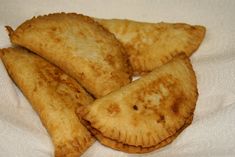 four pieces of fried food sitting on top of a white towel