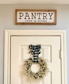 a door with a wreath and sign on it